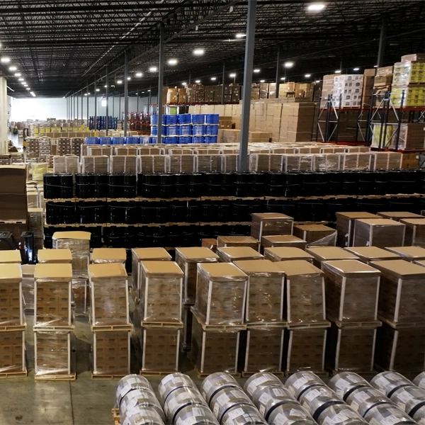 Palletized Items on floor, Stacked pallets on warehouse shelves in background